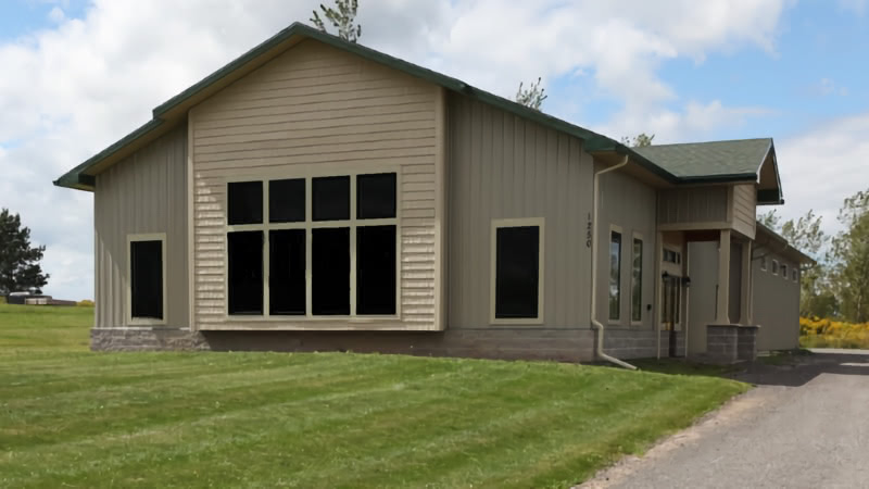 Large brown building with darkened windows.